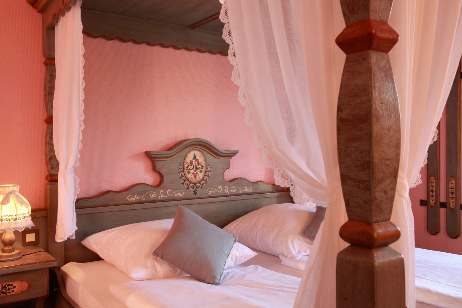 Pink room and wooden bed