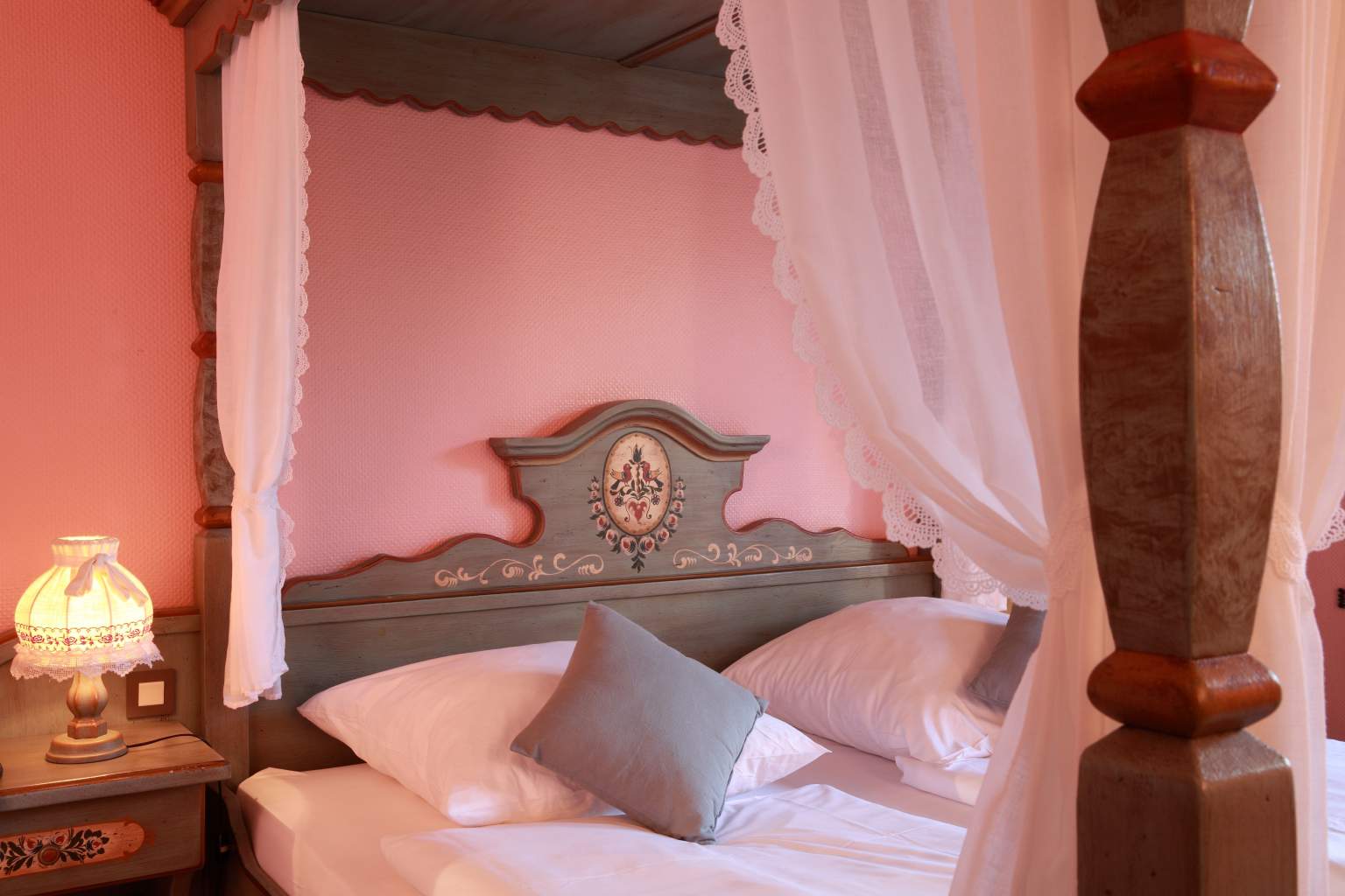 Wooden headboard and pink walls